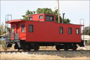 This caboose is not the actual one from the story, but is similar and representative of what the caboose would have looked like after renovation and installation. 