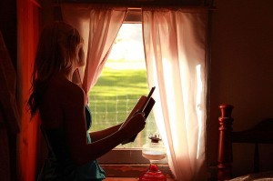 Girl_Holding_Book_Looking_Out_Window_free_creative_commons_(4046234527)