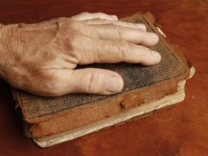 hand-on-bible